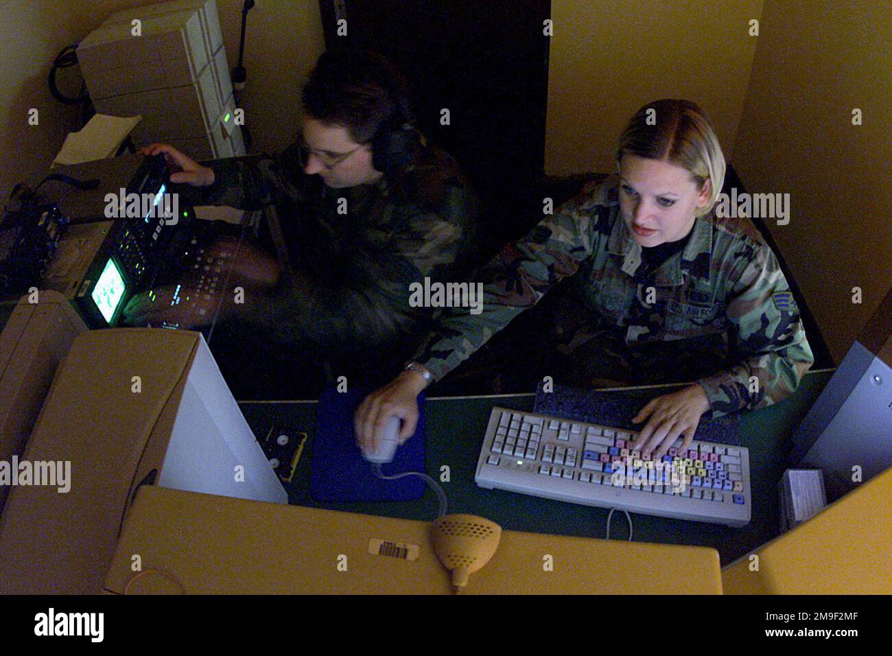 000522-F-4884R-001. [Complete] Scene Caption: SENIOR AIRMAN (SRA) Vanessa Braly, USAF, (right), assists STAFF Sergeant (SSGT) Mike Smith, USAF, editor, review footage captured during COMBINED ENDEAVOR (CE) 2000, at Lager Aulenbach, Germany. Both are with the 1ST Combat Camera Squadron, deployed to provide video and still support for the exercise. CE 2000, currently hosted by Germany, is the largest information and communication systems exercise in the world. This exercise is the sixth in a series of multinational communication interoperability workshops where military personnel from 35 nations Stock Photo
