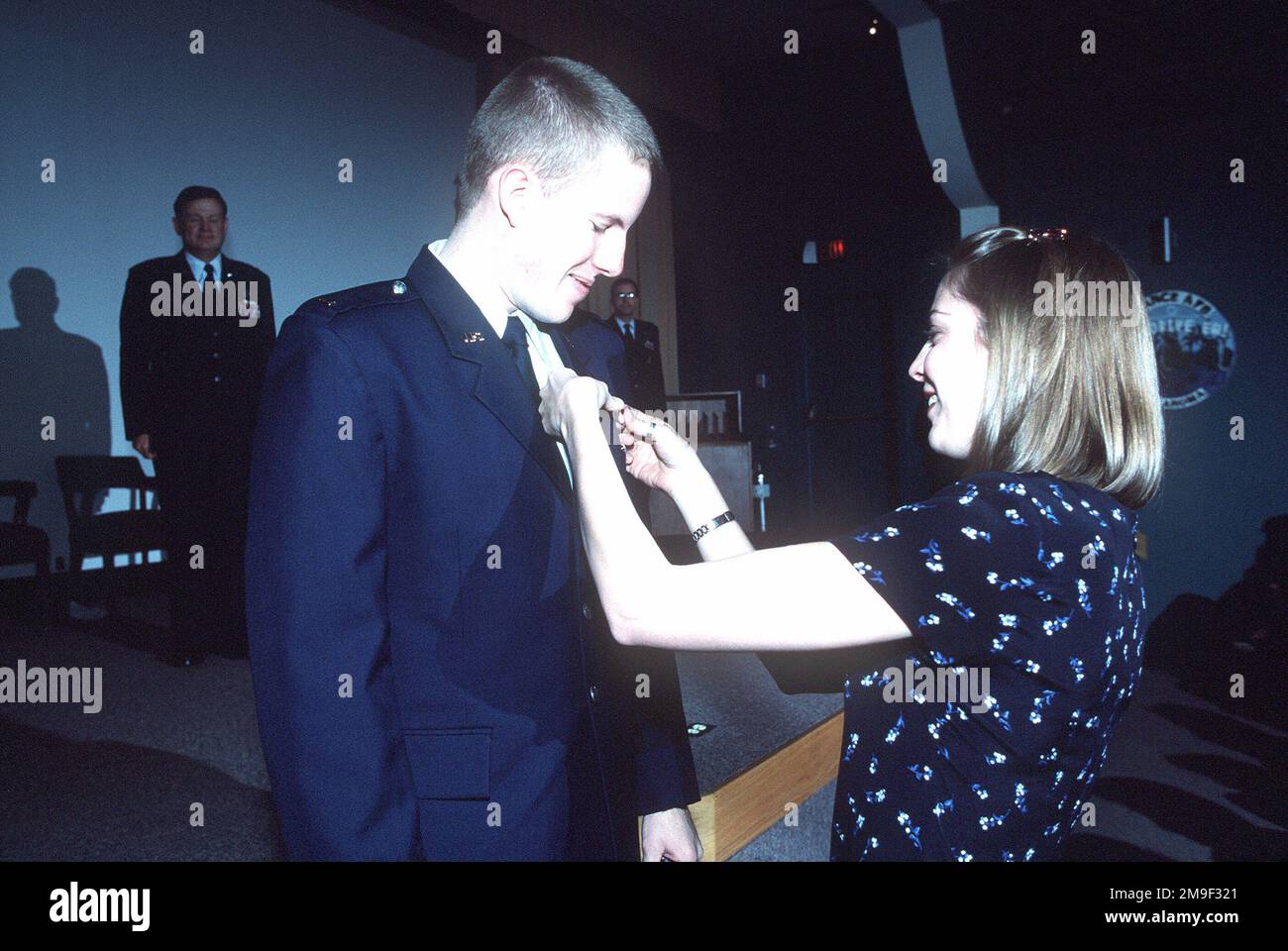 Mrs. Sandra Maeder the wife of US Air Force 2nd Lieutenant Mike Maeder, pins pilot wings on her husband during Graduation Ceremonies for student pilots at Vance AFB, Oklahoma. From then June 2000 AIRMAN Magazine article 'Silver Wing Strut' describing Joint-service pilot training at Vance AFB, Oklahoma. Base: Vance Air Force Base State: Oklahoma (OK) Country: United States Of America (USA) Stock Photo