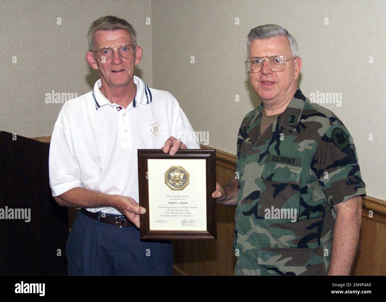 Lieutenant Colonel Dolas Bain presents Robert Brock with an award for ...
