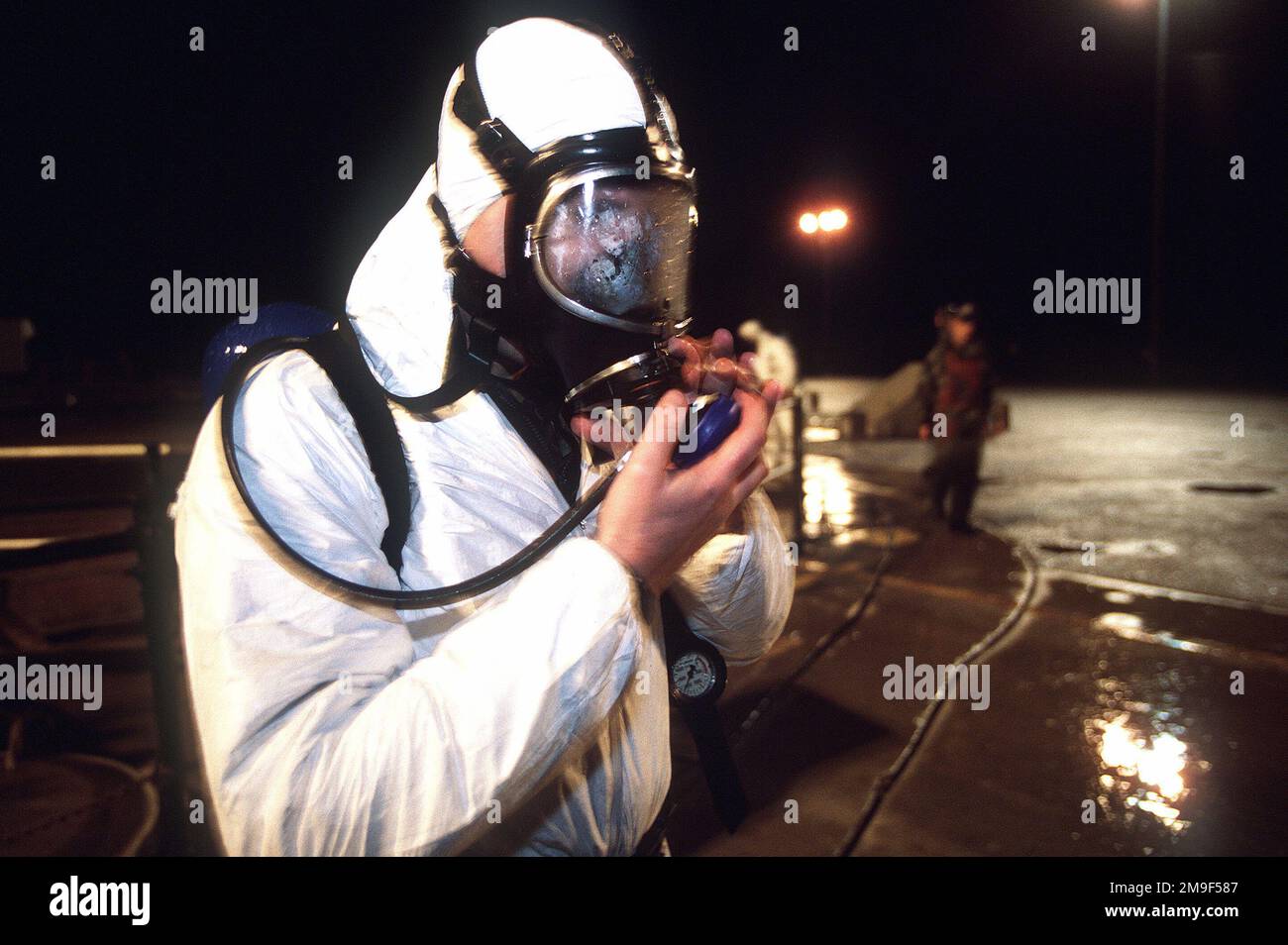 A US Air Force maintainer protects himself from sulfuric hydrochloric