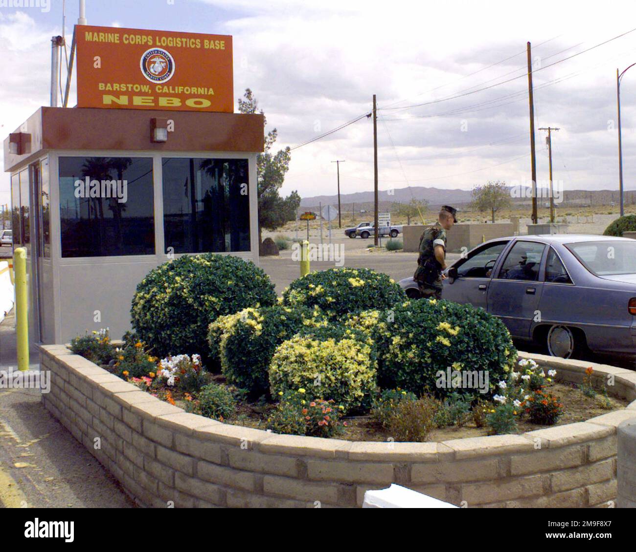 A US Marine gate sentry from the Provost Marshal's Office checks ID at