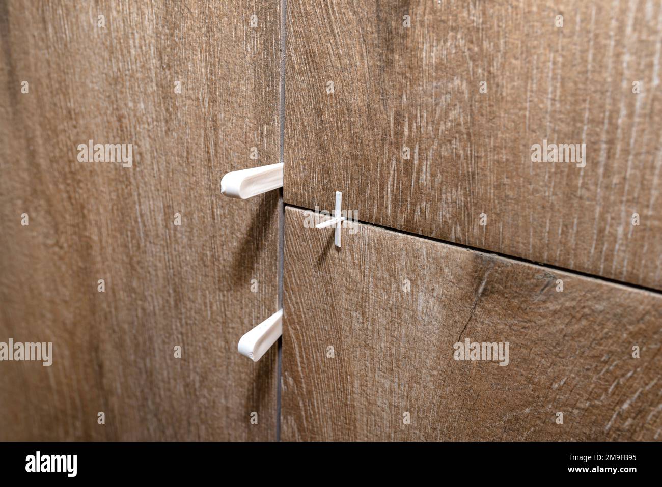 Plastic spacers and distances for laying ceramic tiles, tiles imitating