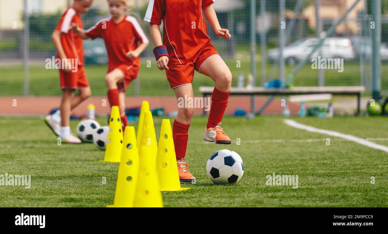 Soccer dribbling drills for young players. Kids running with soccer