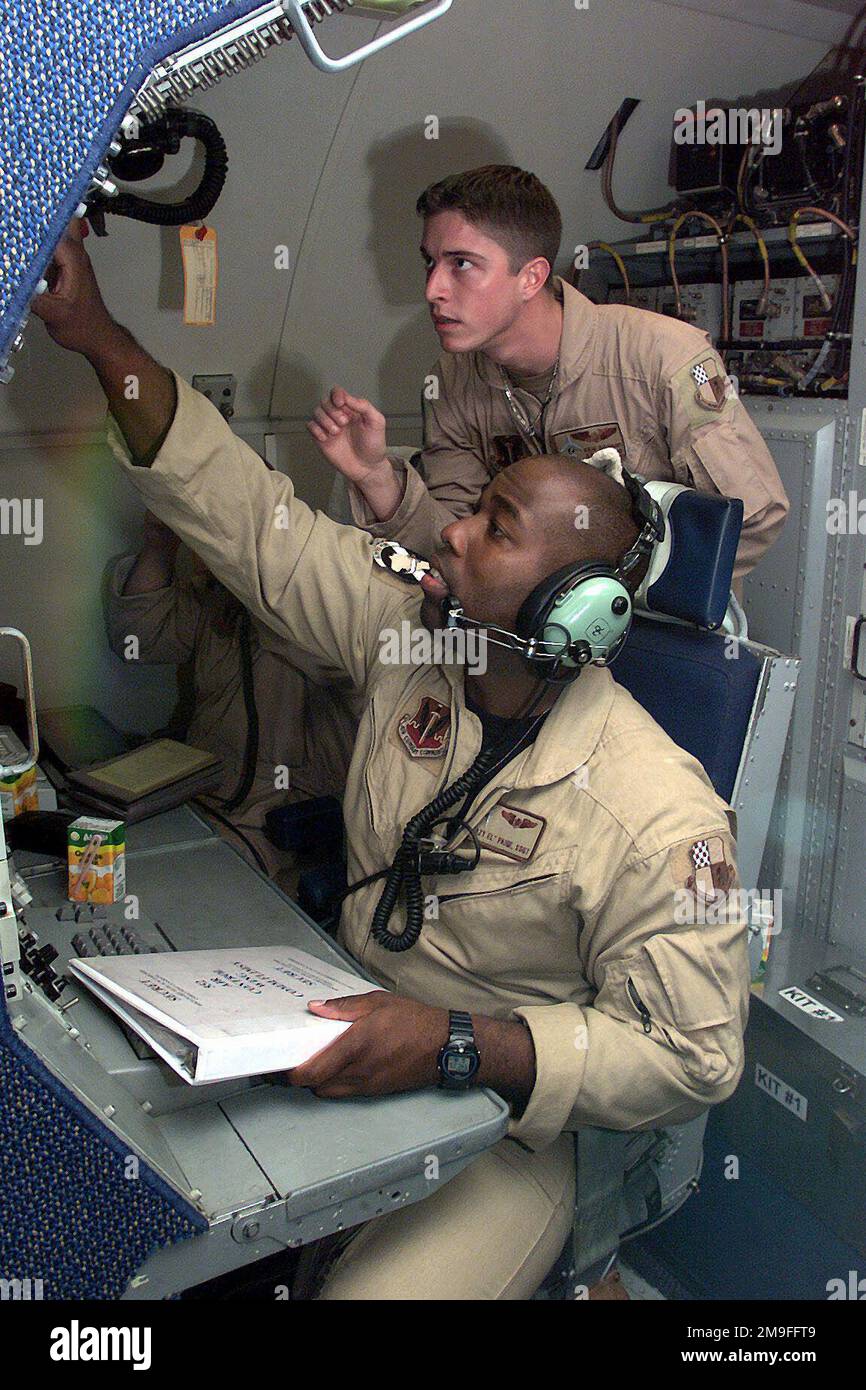 US Air Force SENIOR AIRMAN Ken Graham looks over the shoulder of STAFF ...