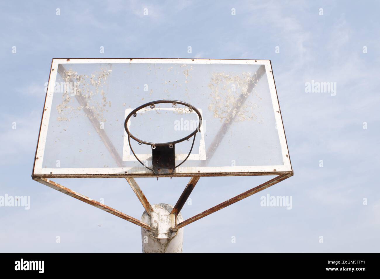 Basketball hoop on blue sky with clouds background Stock Photo