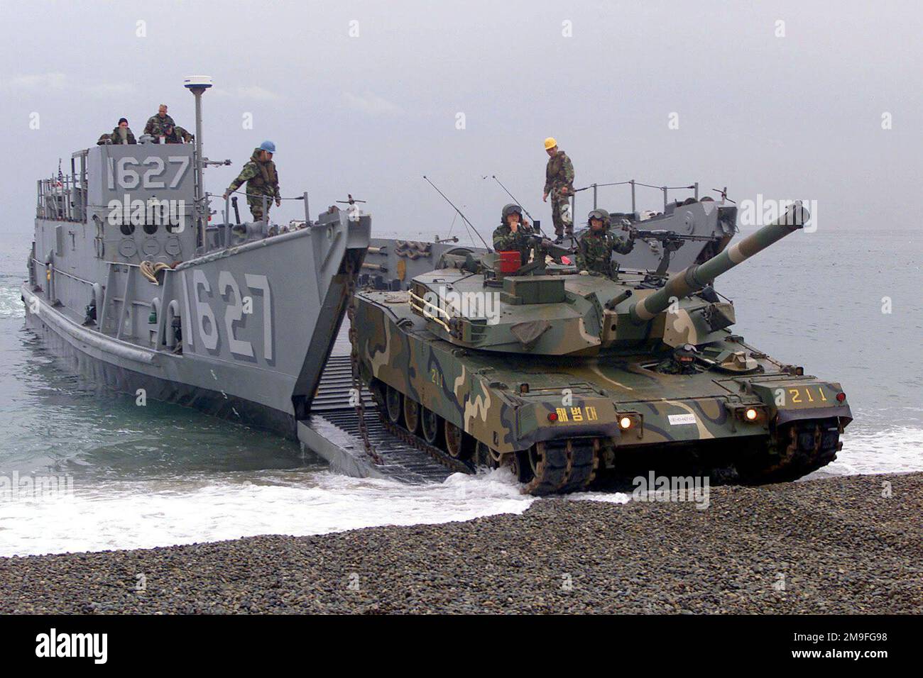 A US Navy Landing Craft Utility (LCU) 1627 prepares to land and unload Republic of Korea Forces and cargo, along with U. S. soldiers from Okinawa, Japan. The tank coming off the ramp of the LCU is a Korean made Type 88 K1 Main Battle Tank with a 105mm M68 rifled tank gun. The combined amphibious beach assault at Tak San Ri Beach near Pohang, is in support of Exercise FOAL EAGLE 2000. FOAL EAGLE is the largest Joint and Combined field training drill conducted annually in South Korea, running from October 25th to November 3rd. About 25,000 U.S. troops will take part in the drill, including activ Stock Photo