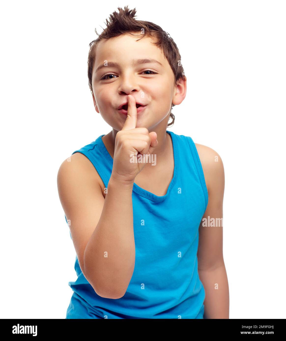 Portrait, secret and children with a boy standing finger on lips in studio isolated on a white background. Kids, whisper and gossip with a male child Stock Photo