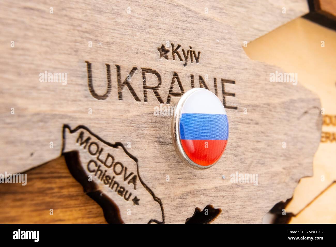 Russia flag on the wooden map of Ukraine. Russian aggression and occupation of Ukraine territory  Stock Photo
