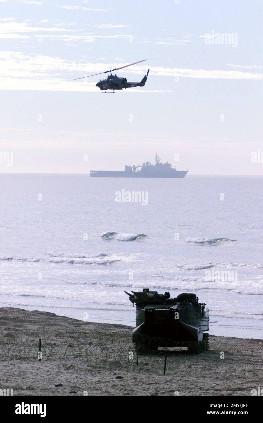 Air (AH-1W Cobra Attack Helicopter), land (AAV, Armored Amphibios Tractor) and sea (LSD, dock landing ship) support is provided, during 50th Anniversary Chosin Reservior Commemoration, at Red Beach, Camp Pendleton, CA. This fierce, bloody battle resulted in 15,000 allied casulties (most of them men of the 1ST Marine Division). 2,500 were killed in action, 5,000 were wounded in action, and 7,500 suffered severe frostbite and cold injuries. The enemy forces sustained 40,000 dead and thousands more were down with wounds and frostbite. Air (AH-1W Cobra Attack Helicopter), land (AAV, Armored Amphib Stock Photo