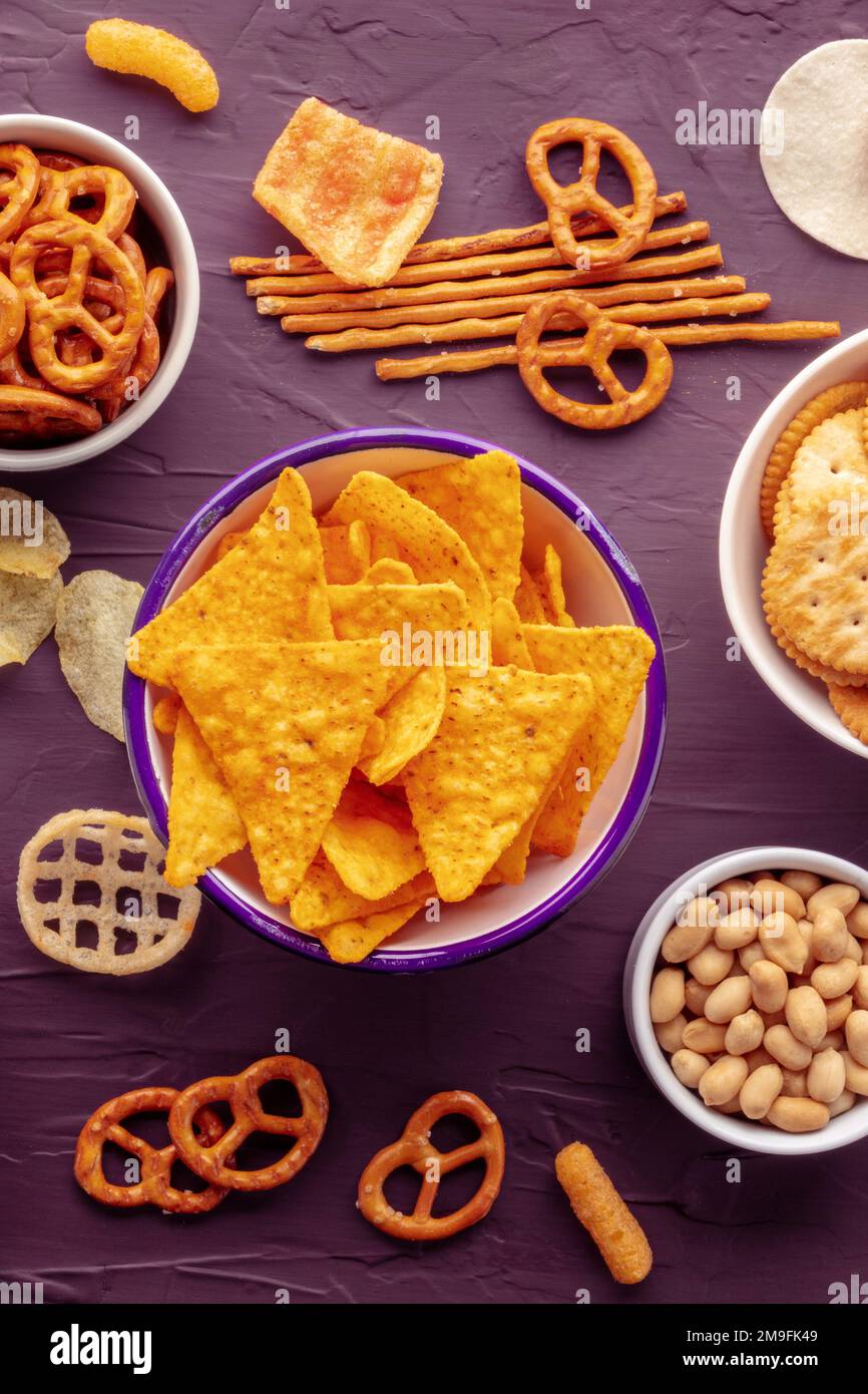 Tortilla chips and other salty snacks, overhead flat lay shot on a