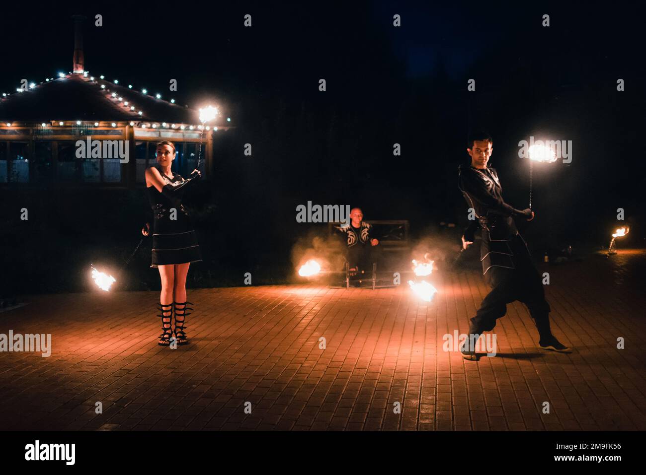 SEMIGORYE, IVANOVO OBLAST, RUSSIA - JULY 16, 2016: Dangerous fire show from the team of professional performers with burning torches and sparks Stock Photo