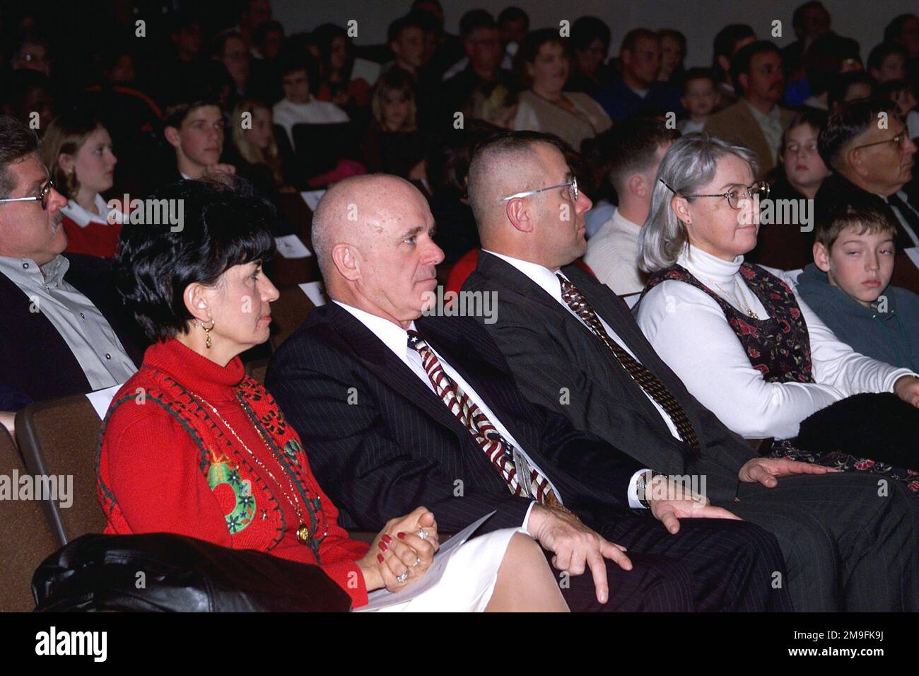Lieutenant General Leon J. Laporte, Commander III Corps and Fort Hood (second from left), his wife Judy (in red), III Corps Command Sergeant Major Dennis Webster, and wife Sandra enjoy the 20th annual performance of Handel's Messiah Concert at Palmer Theater, Fort Hood Texas on 17 December 2000. Base: Fort Hood State: Texas (TX) Country: United States Of America (USA) Scene Major Command Shown: MACOMS Stock Photo