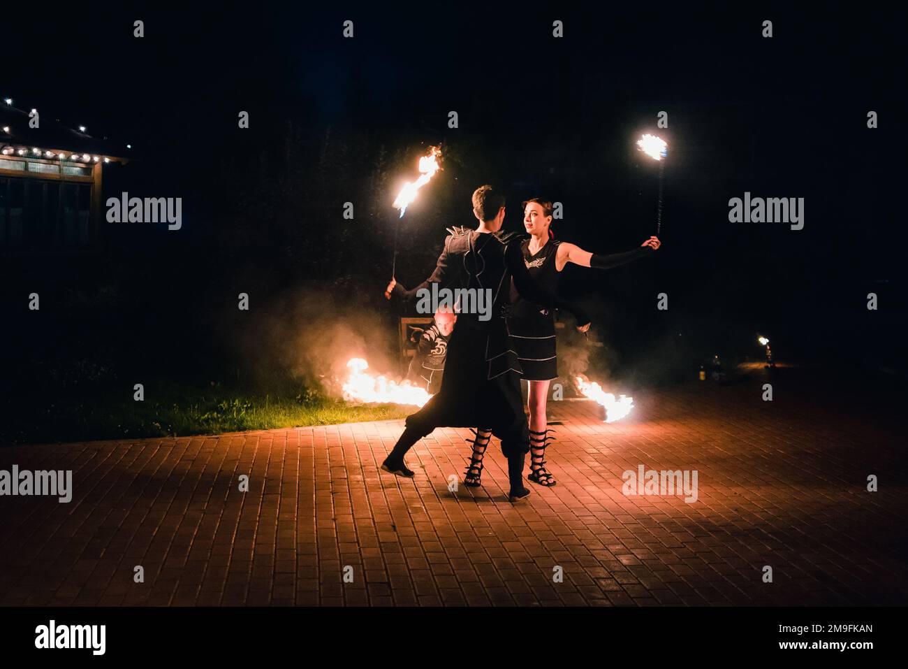 SEMIGORYE, IVANOVO OBLAST, RUSSIA - JULY 16, 2016: Dangerous fire show from the team of professional performers with burning torches and sparks Stock Photo