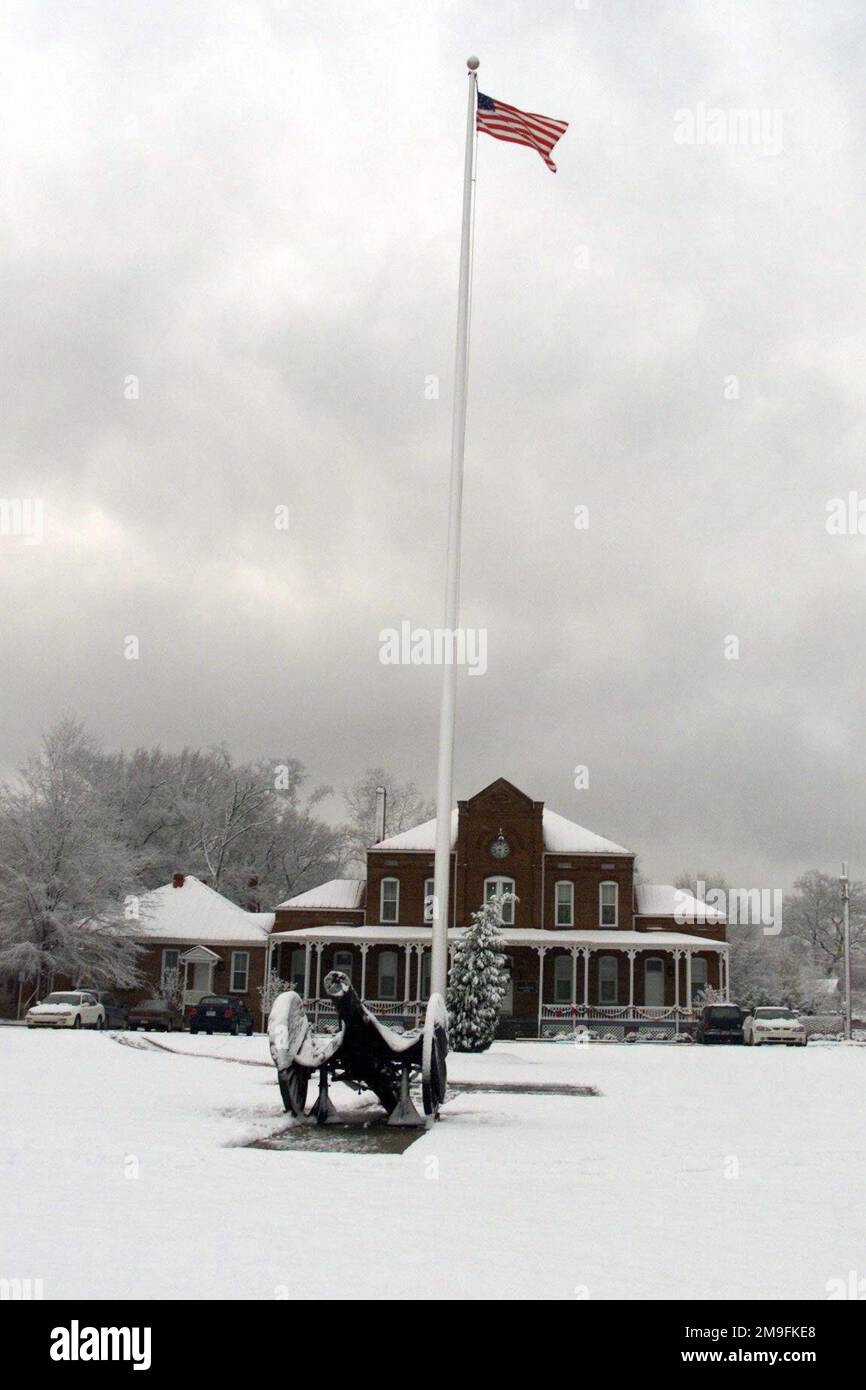 View of the flagpole and cannon on Hedekin Field, Fort McPherson, GA, after a surprise snowfall a week before Christmas. The field is named for Captain Drew Hedekin, the Higher Head Quarters (HHQ) Commander from 1936-1938, an avid Polo player. Behind the flagpole is Van Horn Hall, named for Brigadier General Roberto Van Horn, who held the post's longest command. Base: Fort Mcpherson State: Georgia (GA) Country: United States Of America (USA) Scene Major Command Shown: FORSCOM Stock Photo