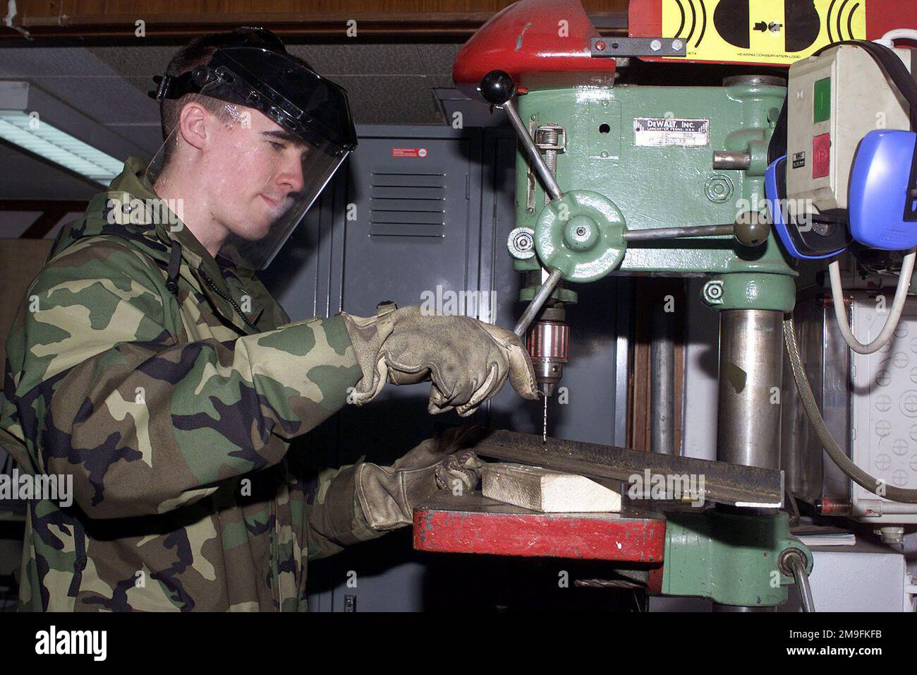 US Air Force AIRMAN Justin Adney, 52nd Civil Engineering Squadron, drills a hole using a drill press machine to build a stand for a gas burner at Spangdahlem Air Base, Germany. Base: Spangdahlem Air Base State: Rheinland-Pfalz Country: Deutschland / Germany (DEU) Stock Photo
