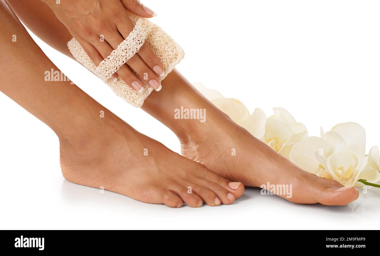 Scrub, pedicure and woman feet in studio for spa, luxury and skincare with floral product