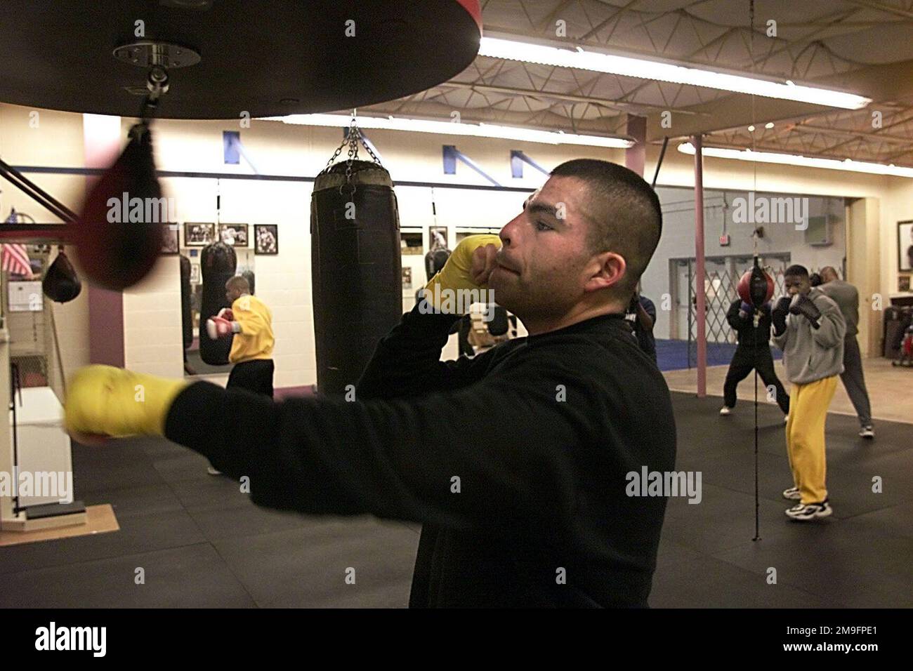 US Army boxer Carlos Ibarra trains on the speed bag at Barnes Field House gymnasium. Boxers from all four of the US military services are competing in this year's Armed Forces Boxing Competition at Fort Huachuca, Arizona, February 7th, 2001. Base: Fort Huachuca State: Arizona (AZ) Country: United States Of America (USA) Stock Photo