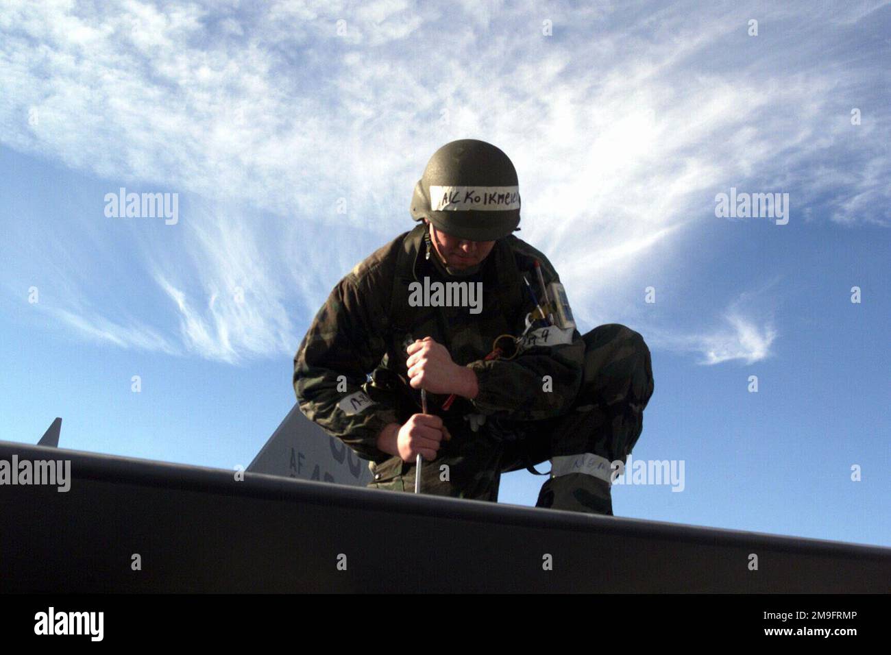 US Air Force AIRMAN First Class Wally A. Kolkmier loosens a panel on