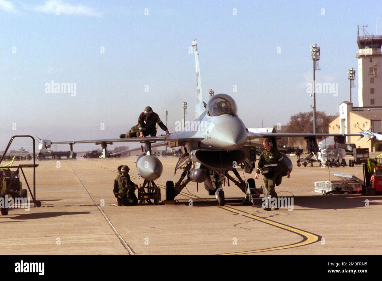 Members of the 524th Fighter Squadron check an F16 Fighting Falcon