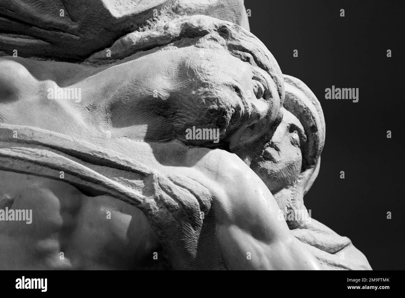 Black and white photo showing in detail the faces of stone sculptures representing Virgin Mary and dead Jesus Stock Photo