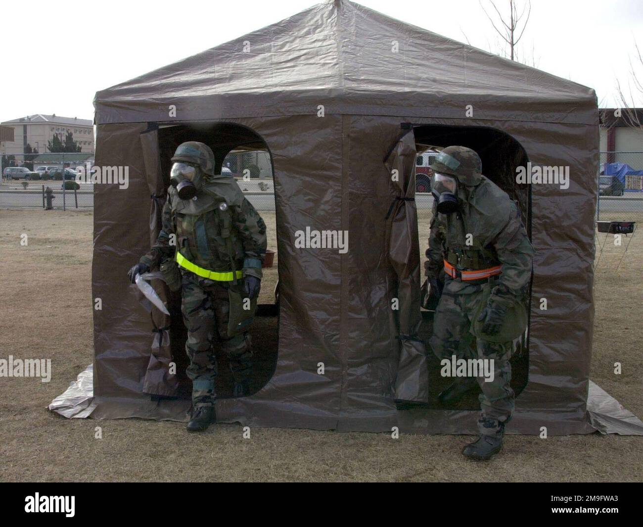 US Air Force Airmen of the 8th Communications Squadron, Kunsan Air Base,  Republic of Korea, wear Mission-Oriented Protective Posture response level  4 (MOPP-4) gear as they exit the rinse off tent the