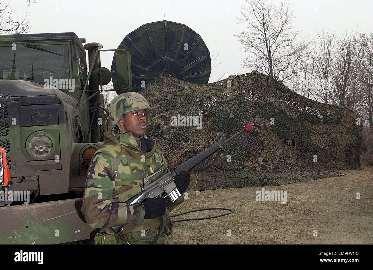 US Air Force AIRMAN First Class Daryl Hardeman, 607th Combat Communications Squadron, stands on patrol with an M16A2 rifle at a Satellite Communications (SATCOM) site during the Operational Readiness Inspection at Osan Air Base, Republic of Korea. Base: Osan Air Base Country: Republic Of Korea (KOR) Stock Photo