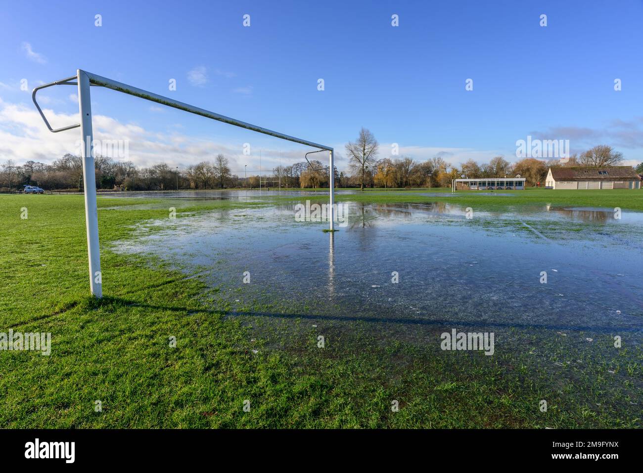 Weather: Flooded football pitch and recreation ground  with rain turned to ice after hard frost overnight, Fordingbridge, Hampshire, UK, 18th January 2023. Stock Photo