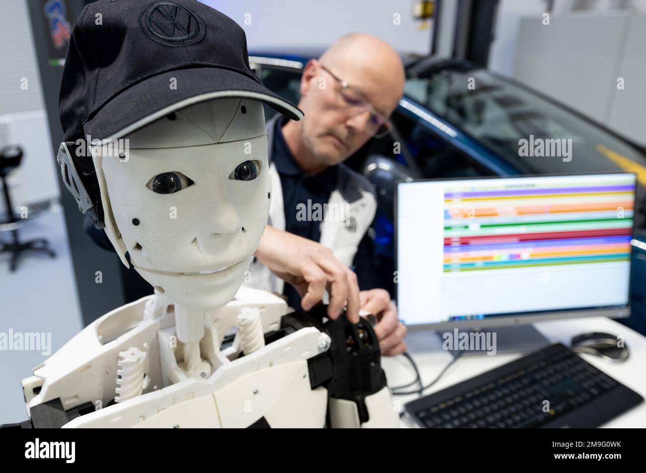 Zwickau, Germany. 18th Jan, 2023. René Tuchscherer, trainer at the Volkswagen Training Institute in Zwickau, shows a humanoid that was constructed and programmed by trainees. Volkswagen has expanded its training institute in Zwickau. After nearly three years of construction and investments totaling 15 million euros, the Future e-Mobility Campus now offers new training and continuing education formats for the automotive and supplier industries. Digitalization, autonomous driving and e-mobility are the focus here. Credit: Hendrik Schmidt/dpa/Alamy Live News Stock Photo