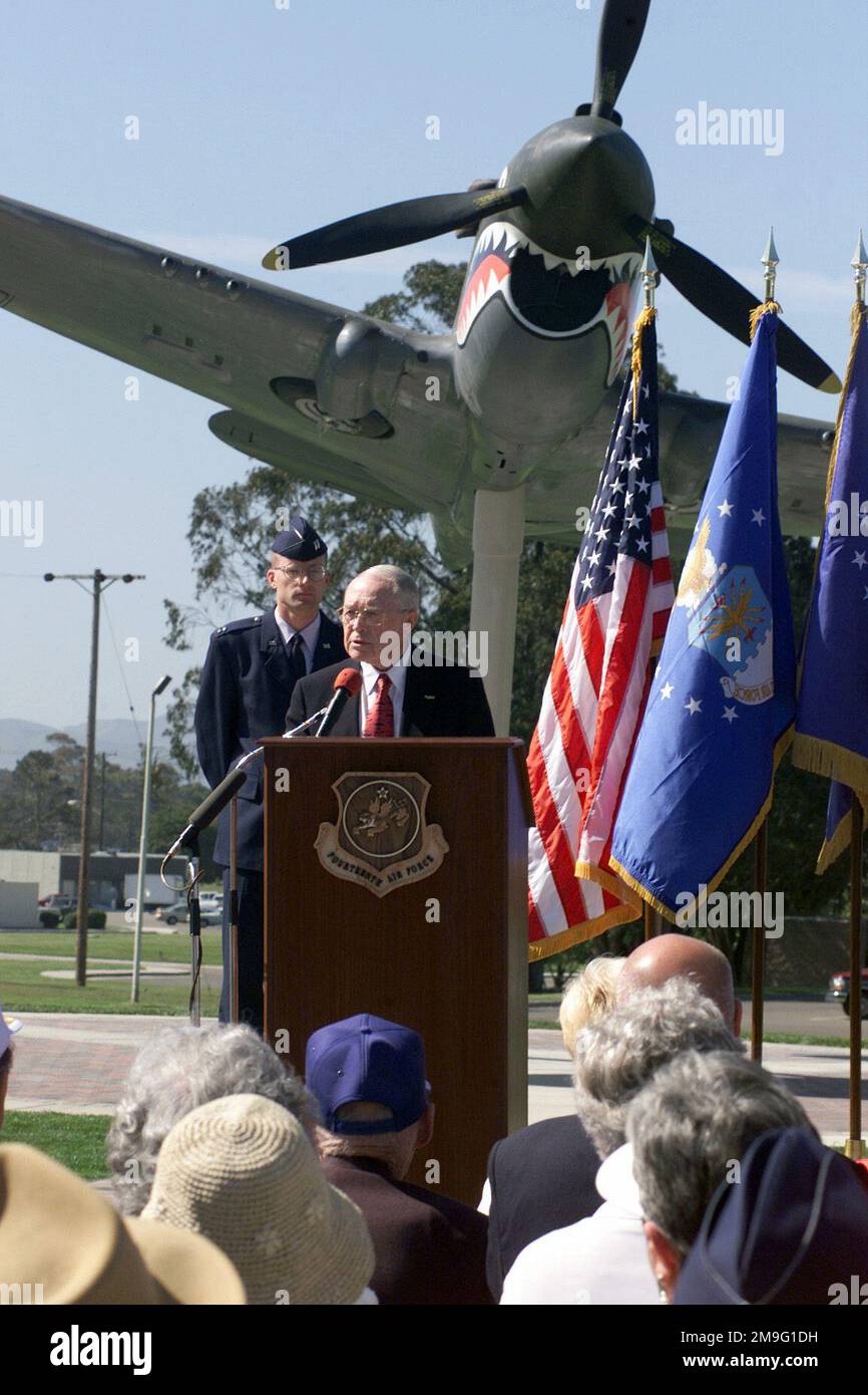 With the P-40E Tomahawk memorial in the background, Clifford Long 14th Air Force Association president and former P-40 pilot addresses a gathering of 200 guests at the unveiling ceremony. The P-40 'serves as, a monument, not to the aircraft but to the people of the original Flying Tigers, and as reminder to their modern-day counter-parts.' The Tomahawk memorial, funded by the 14th Air Force with Major General William R. Looney III in command, took three months from ground breaking to the dedication ceremony. Base: Vandenberg Air Force Base State: California (CA) Country: United States Of Ameri Stock Photo