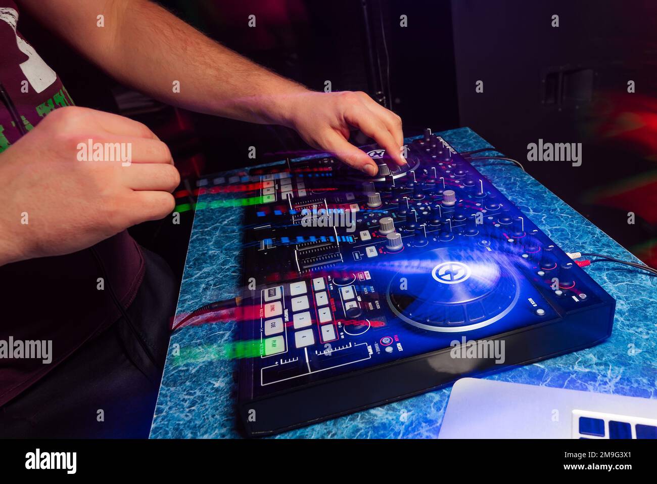 hands DJ playing and mixing music on a modern music controller at a