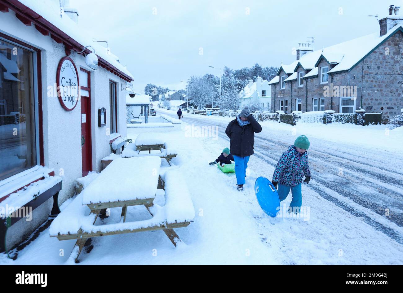 People walk through the snow in Carrbridge, Scotland, Britain January 18, 2023. REUTERS/Russell Cheyne Stock Photo