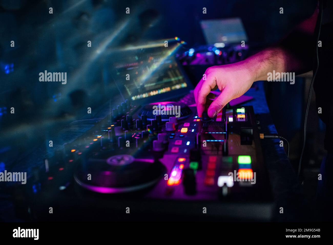 hands DJ playing and mixing music on a modern music controller at a
