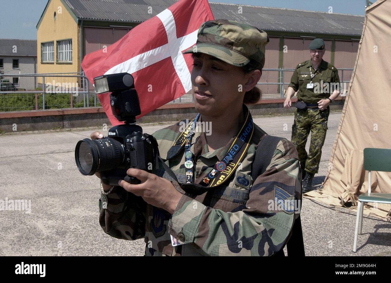 US Air Force STAFF Sergeant Jocelyn Broussard, a photographer from US Air Forces in Europe, shoots photos at the Danish delegation's tent in Lager Aulenbach, Germany, during Exercise COMBINED ENDEAVOR, the largest communications and information systems exercise in the world. The exercise, sponsored by US European Command and hosted by Germany in the spirit of 'Partnership for Peace,' is held annually to test and document the interoperability of dozens of nations and NATO. Subject Operation/Series: COMBINED ENDEAVOR 2001 Base: Lager Aulenbach State: Rheinland-Pfalz Country: Deutschland / German Stock Photo