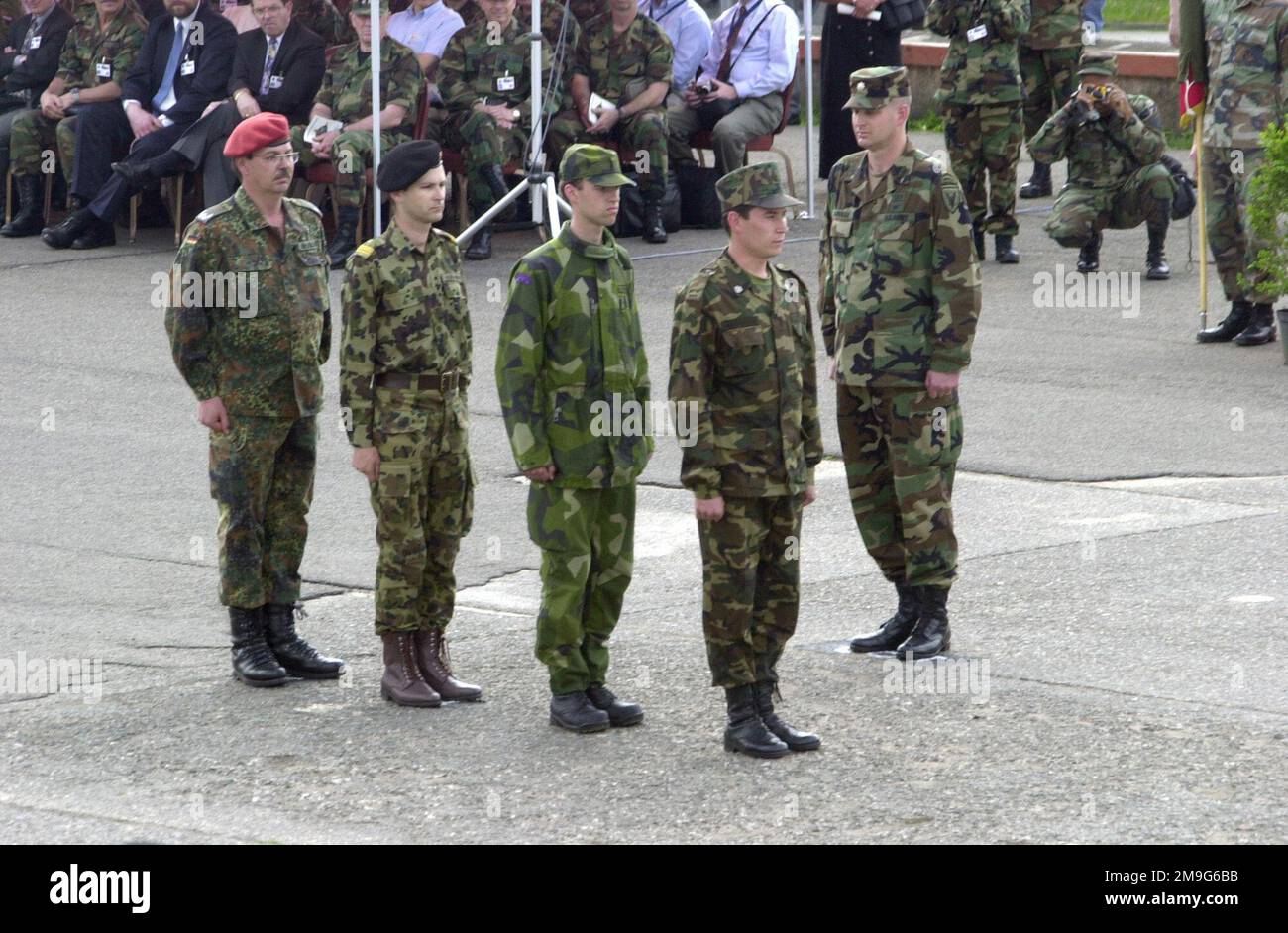 Participants of COMBINED ENDEAVOR 2001 stand at attention at the closing ceremony. This marks the end of the Combined Endeavor in Lager Aulenbach, Germany. Sponsored by the US European Command and hosted by Germany, the exercise is held annually to test and document the interoperability of dozens of countries and NATO. The largest communications and information systems in the world, 37 countries participated this year. Subject Operation/Series: COMBINED ENDEAVOR 2001 Base: Lager Aulenbach State: Rheinland-Pfalz Country: Deutschland / Germany (DEU) Stock Photo