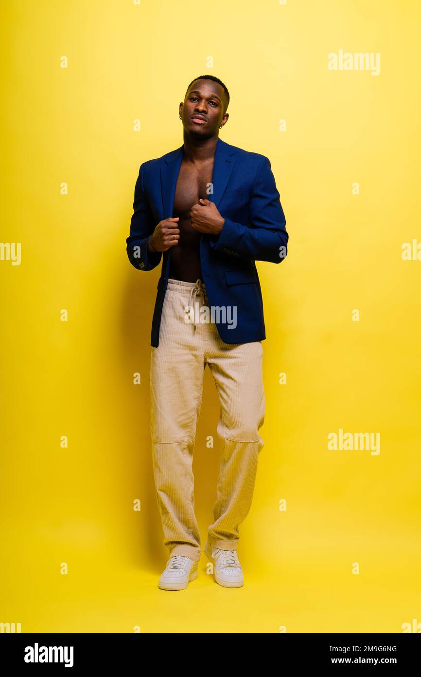 Smiling young african american man guy isolated on yellow background ...