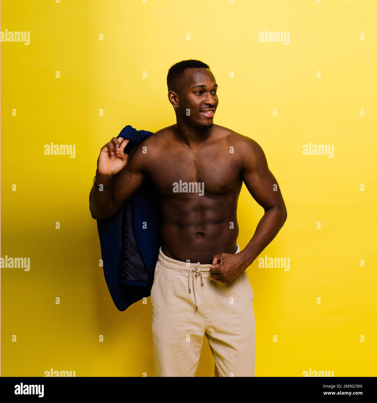 Smiling young african american man guy isolated on yellow background ...