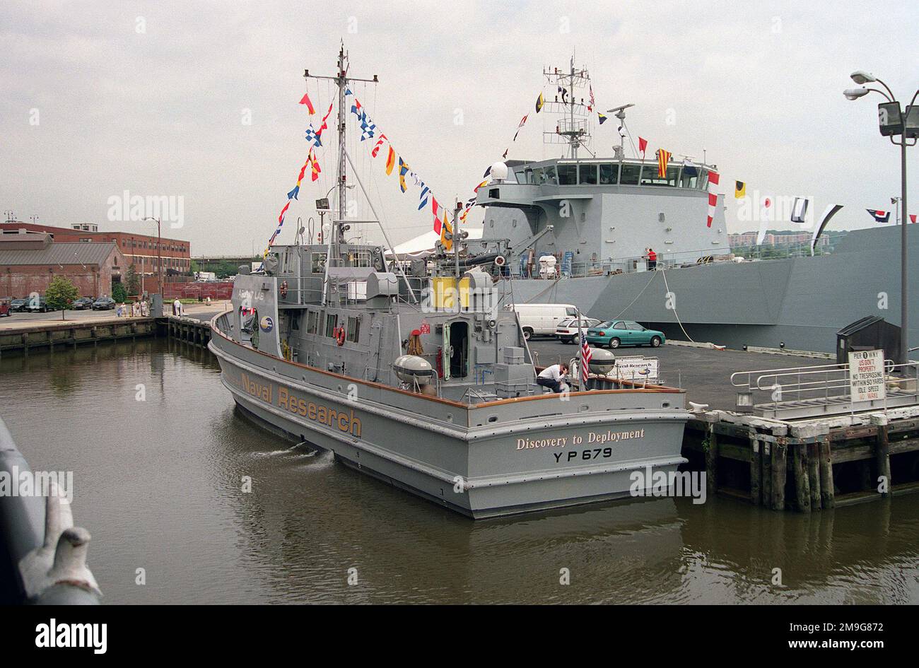 Port quarter view of the Navy yard patrol craft 679 (YP 679) tied up at pier one at the Washington Navy Yard. YP 679 is presently assigned to the Office of Naval Research as a float lab. On the opposite side of the pier is the United Kingdom research vessel RV TRITON which is here on a port visit. Base: Anacostia River State: District Of Columbia (DC) Country: United States Of America (USA) Stock Photo