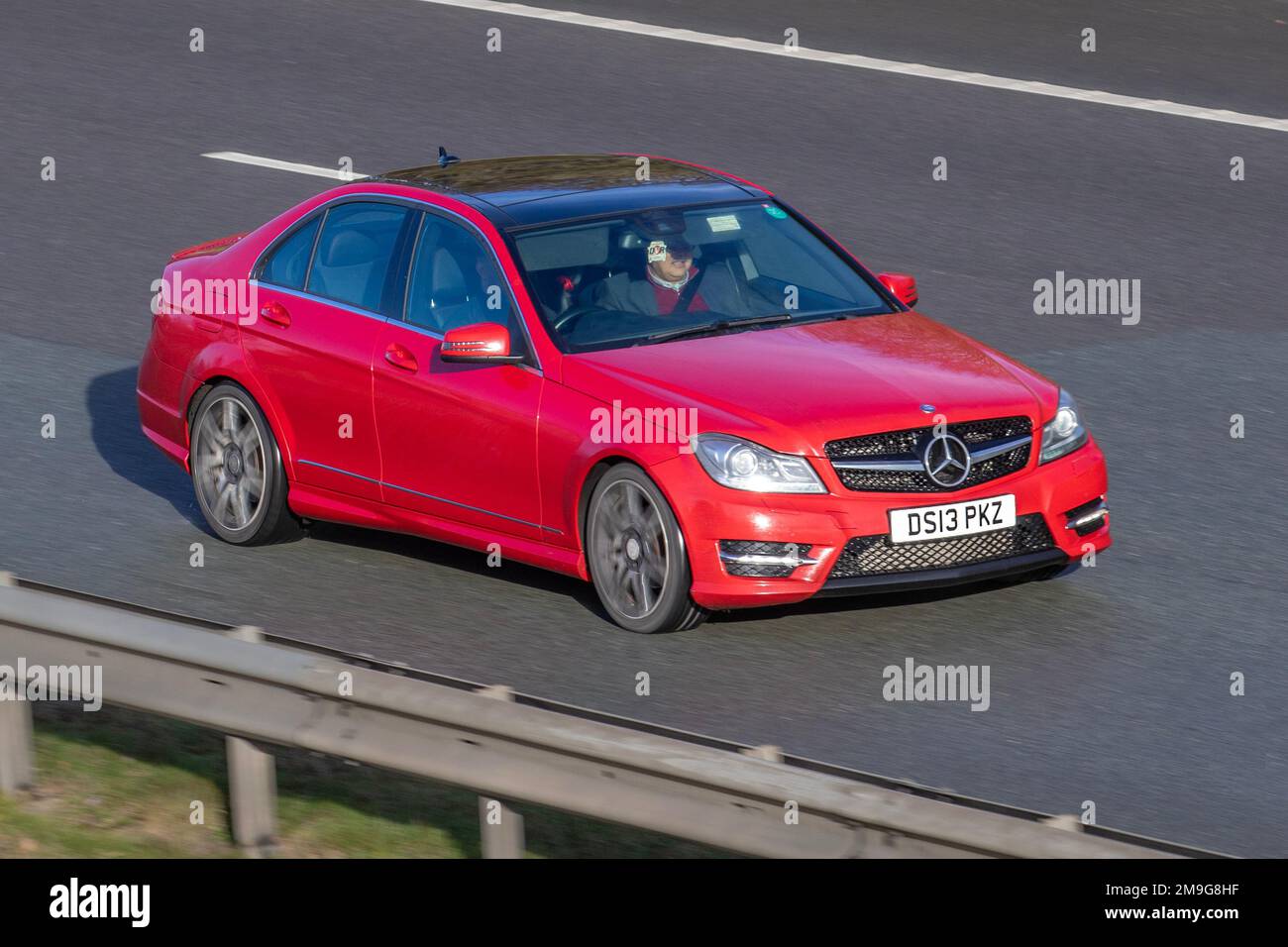 2013 Red Mercedes Benz C C250 BLUEEFFICIENCY AMG SPORT PLUS 2143 cc 7 speed manual; travelling on the M61 motorway, UK Stock Photo