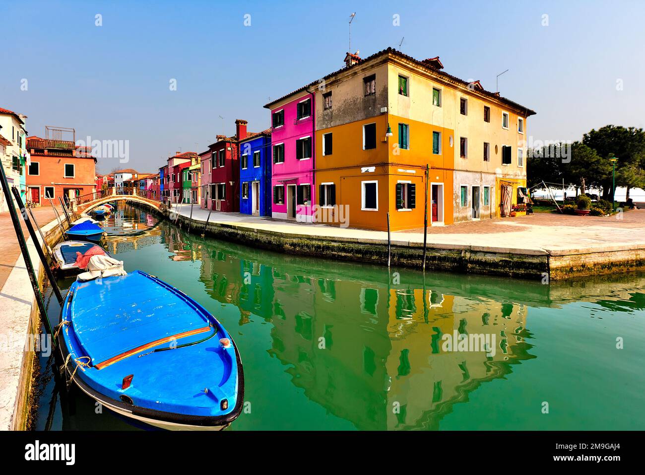 Vibrant colored townhouses on bank of canal, Burano Island, Venice, Italy Stock Photo