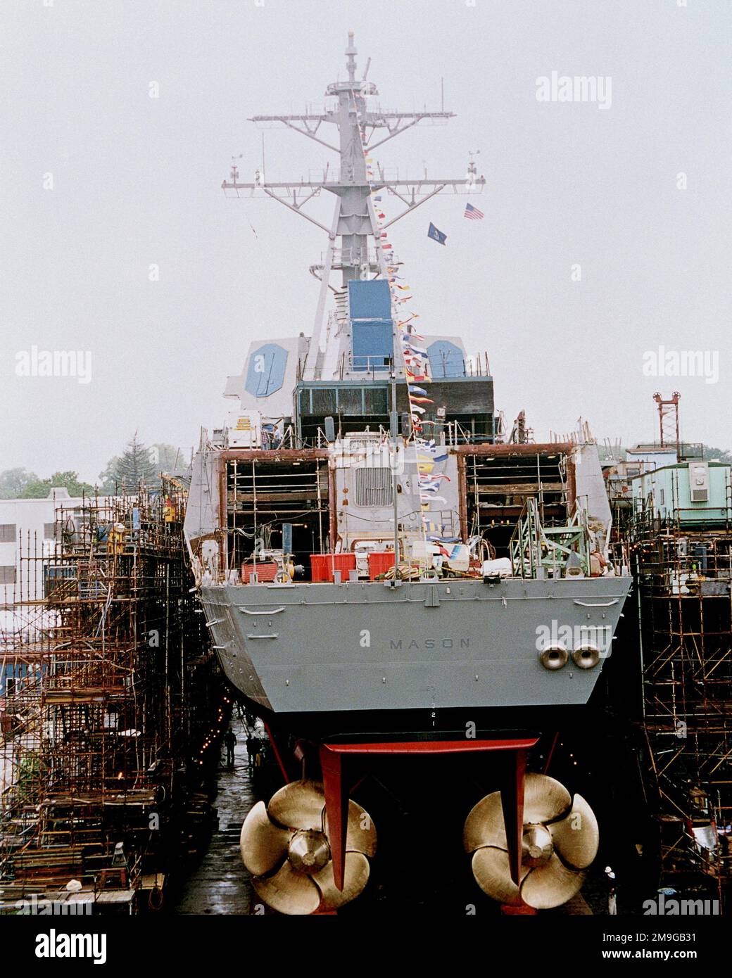 Direct stern-on view of the Arleigh Burke class Aegis guided missile destroyer USS MASON (DDG 87) resting on the launch ways shortly before her christening at the Bath Iron Works Shipyard. The ships large bronze screws are visible in the view. This is the last Navy ship to be launched down the traditional inclined way. Base: Bath State: Maine (ME) Country: United States Of America (USA) Stock Photo