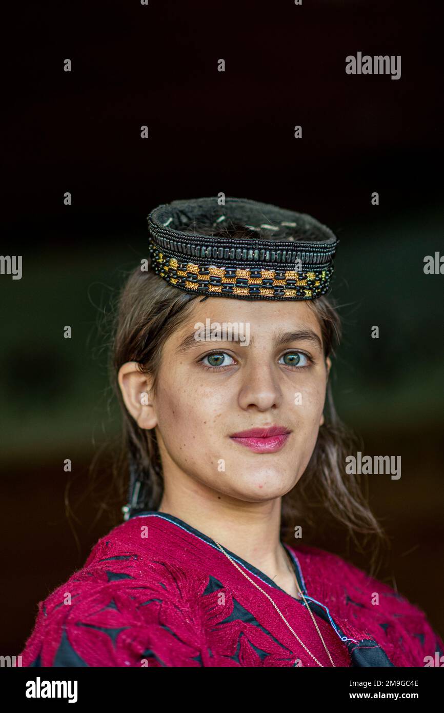 Portrait of a Kalash beautiful girl with traditional beaded headdress ...