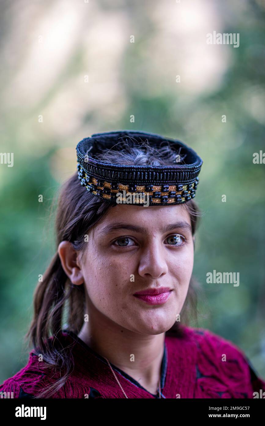 Portrait of a Kalash beautiful girl with traditional beaded headdress ...