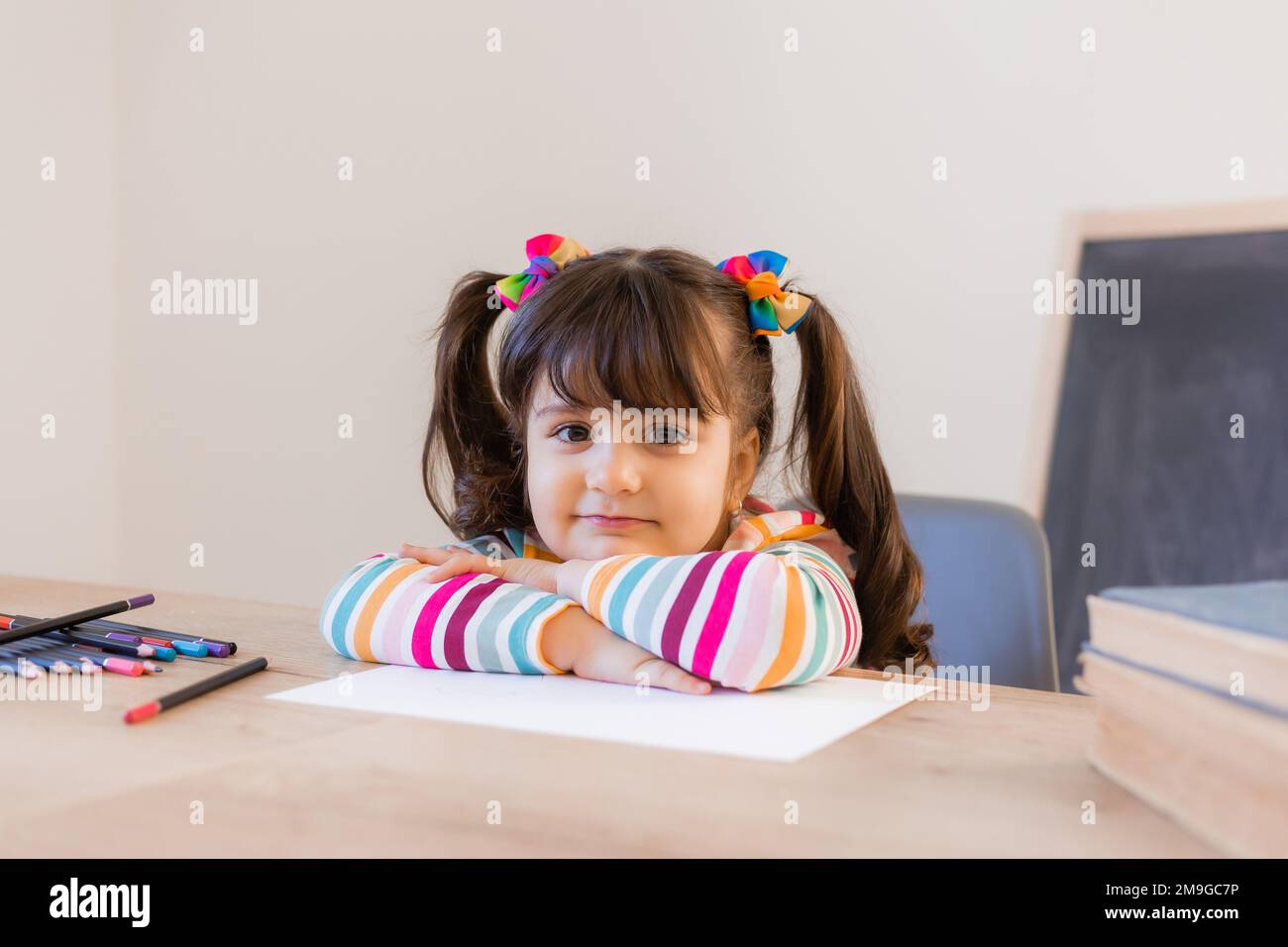 cute little girl draws with colored pencils Stock Photo - Alamy