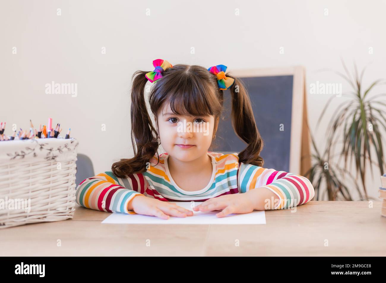cute little girl draws with colored pencils Stock Photo - Alamy