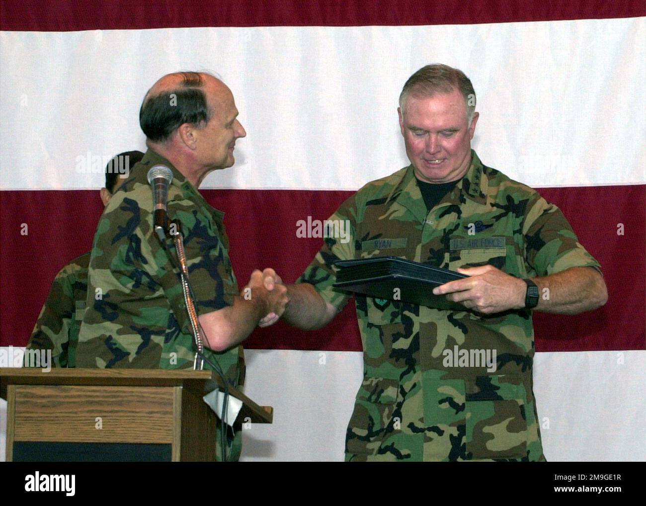 (L) General (GEN) Gregory S. Martin, US Air Forces Europe (USAFE) Commander, presents GEN Michael Ryan, Air Force CHIEF of STAFF, with a scrap book showcasing USAFE, during an all hands call with GEN Ryan during his final visit to Ramstein Air Base, Germany. Base: Ramstein Air Base State: Rheinland-Pfalz Country: Deutschland / Germany (DEU) Scene Major Command Shown: USAFE Stock Photo