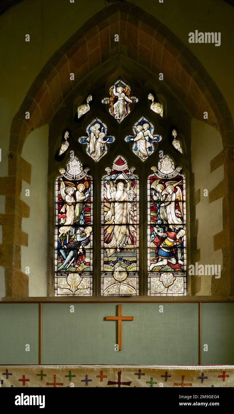 The resurrected Jesus Christ with angels and saints - a stained glass window at the medieval christian church in the village of Wilbarston, England. Stock Photo