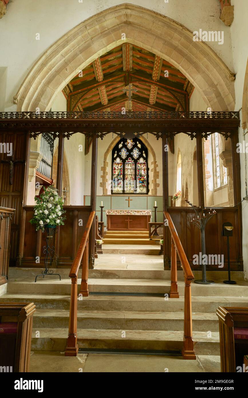The raised chancel at the medieval fourteenth century christian church in the village of Wilbarston, England. Stock Photo