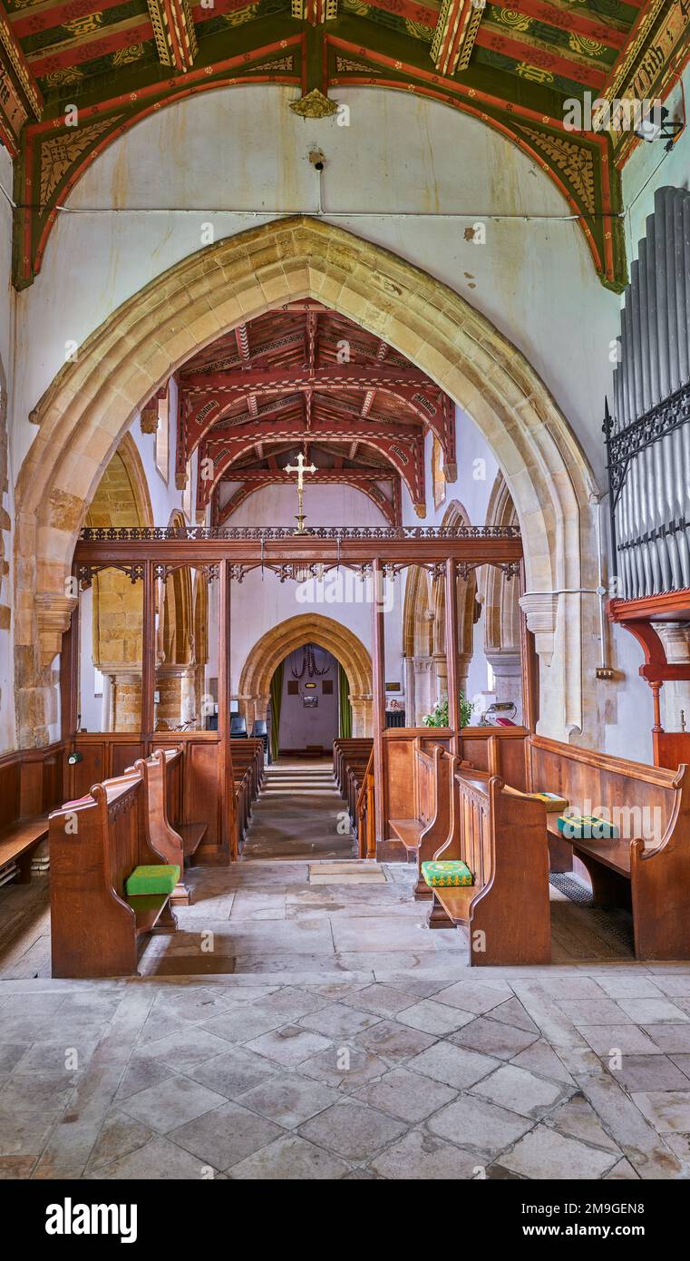 The chancel and nave at the medieval fourteenth century christian church in the village of Wilbarston, England. Stock Photo
