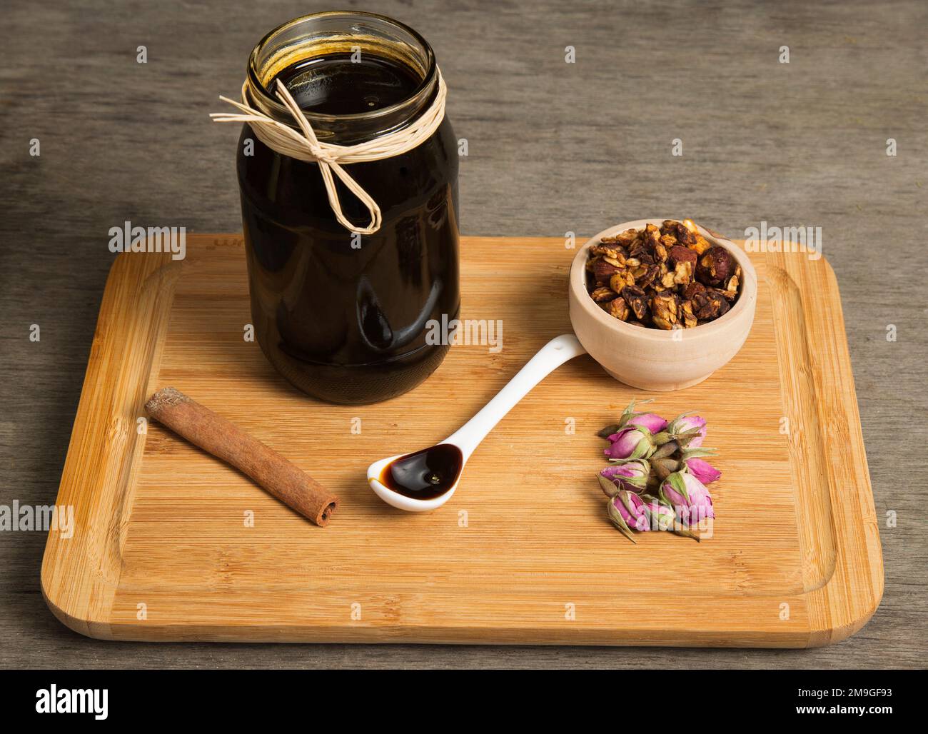 Grape molasses in a jar, with granola Stock Photo Alamy
