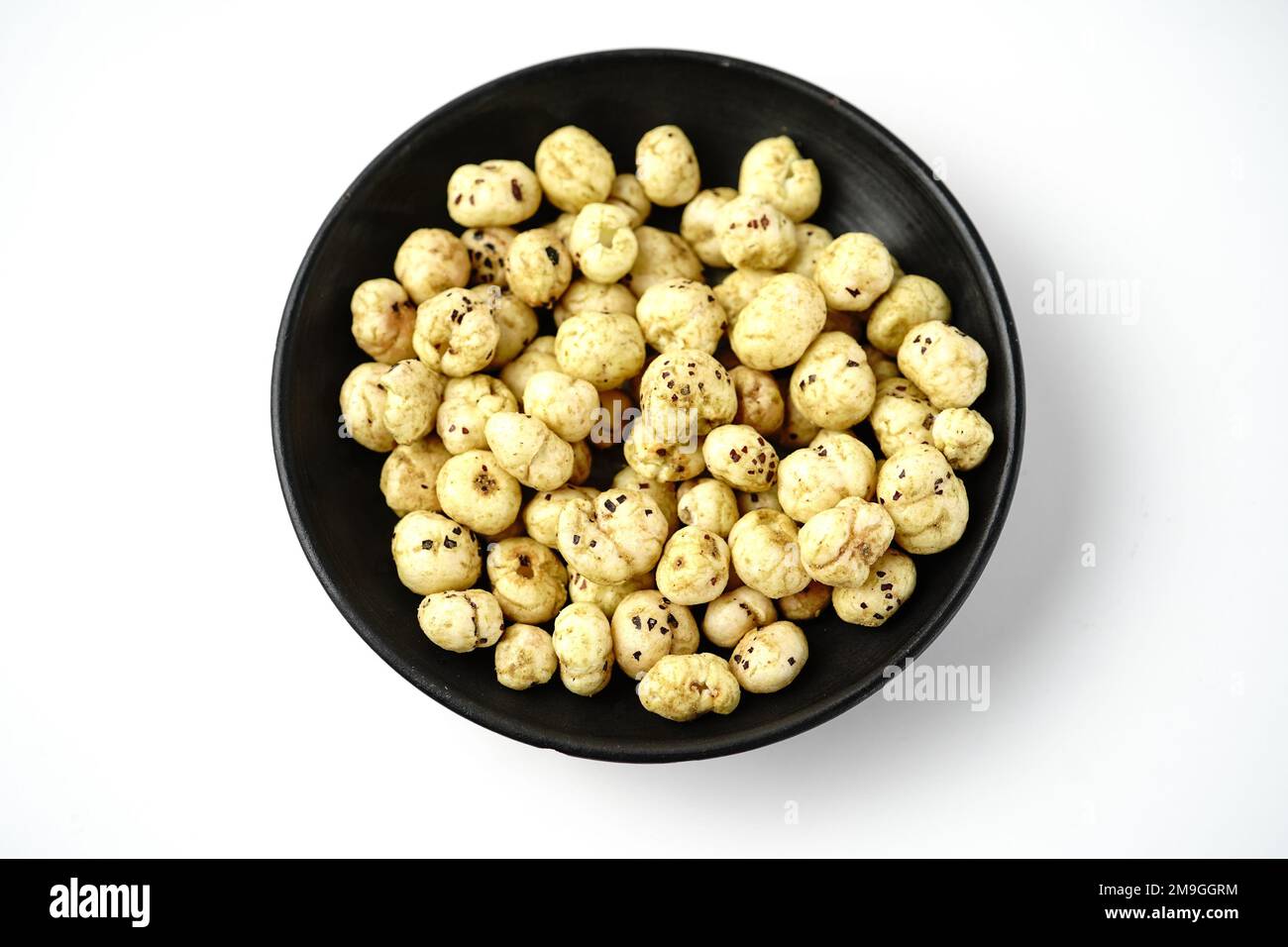 Makhana, also called as Lotus Seeds or Fox Nuts are popular dry snacks from India, served in a bowl Stock Photo